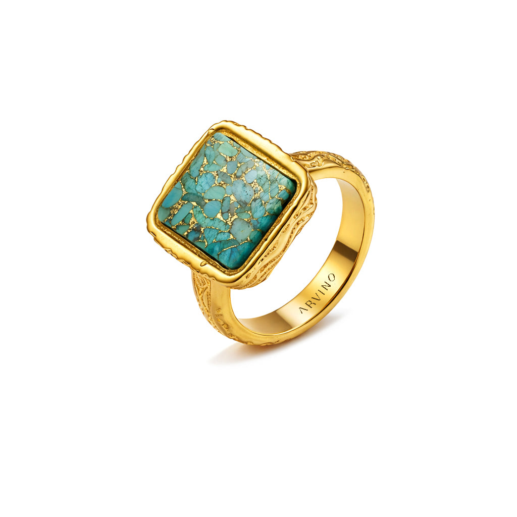 Gold ring with turquoise stone on a white background