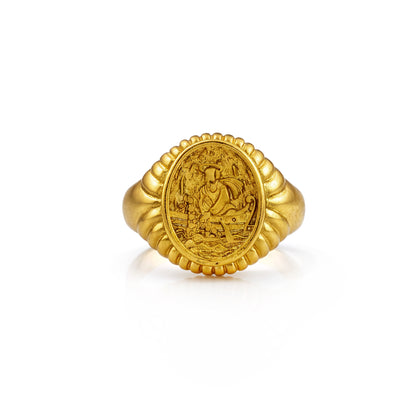 Gold ring with intricate design on a white background