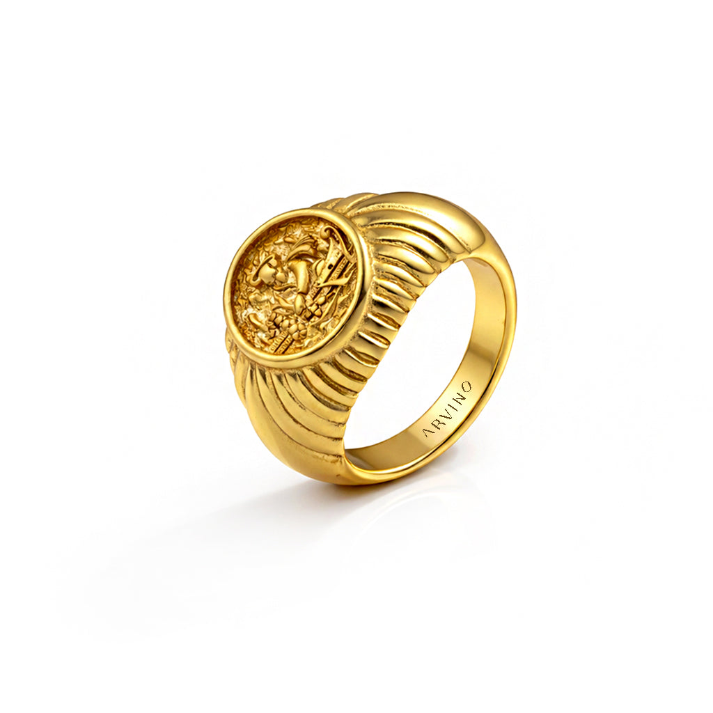 Gold ring with a detailed design on a white background