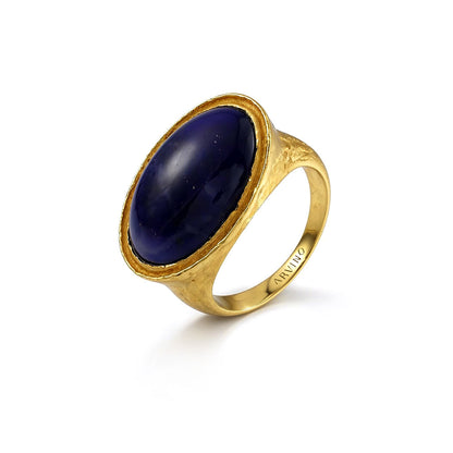 Gold ring with a blue stone on a white background