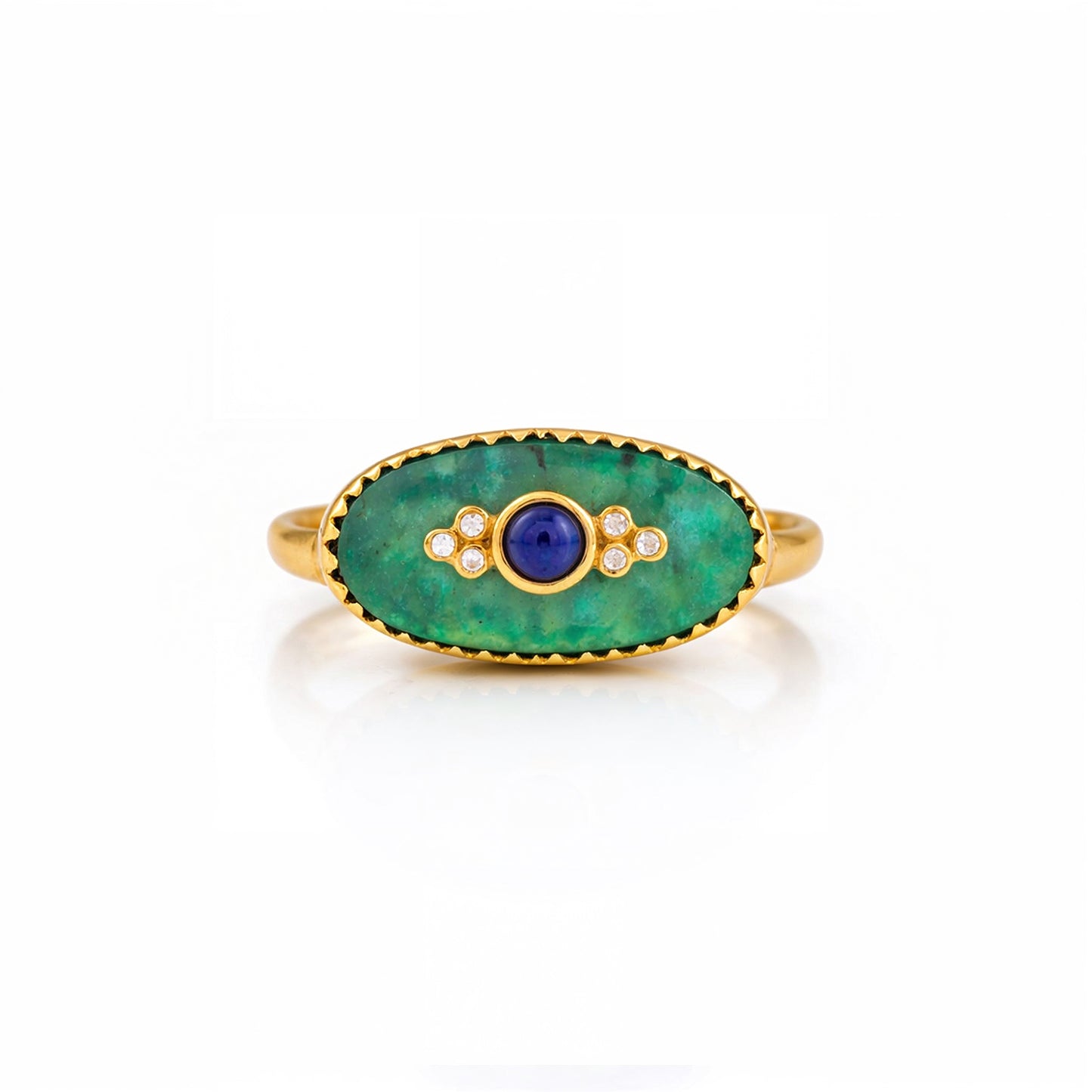 Gold ring with green stone and blue center on a white background