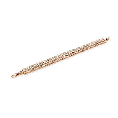 Rose gold bracelet with clear stones on a white background