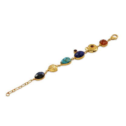 Gold bracelet with gemstone charms on a white background