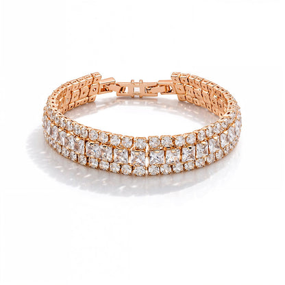 Rose gold bracelet with clear gemstones on a white background
