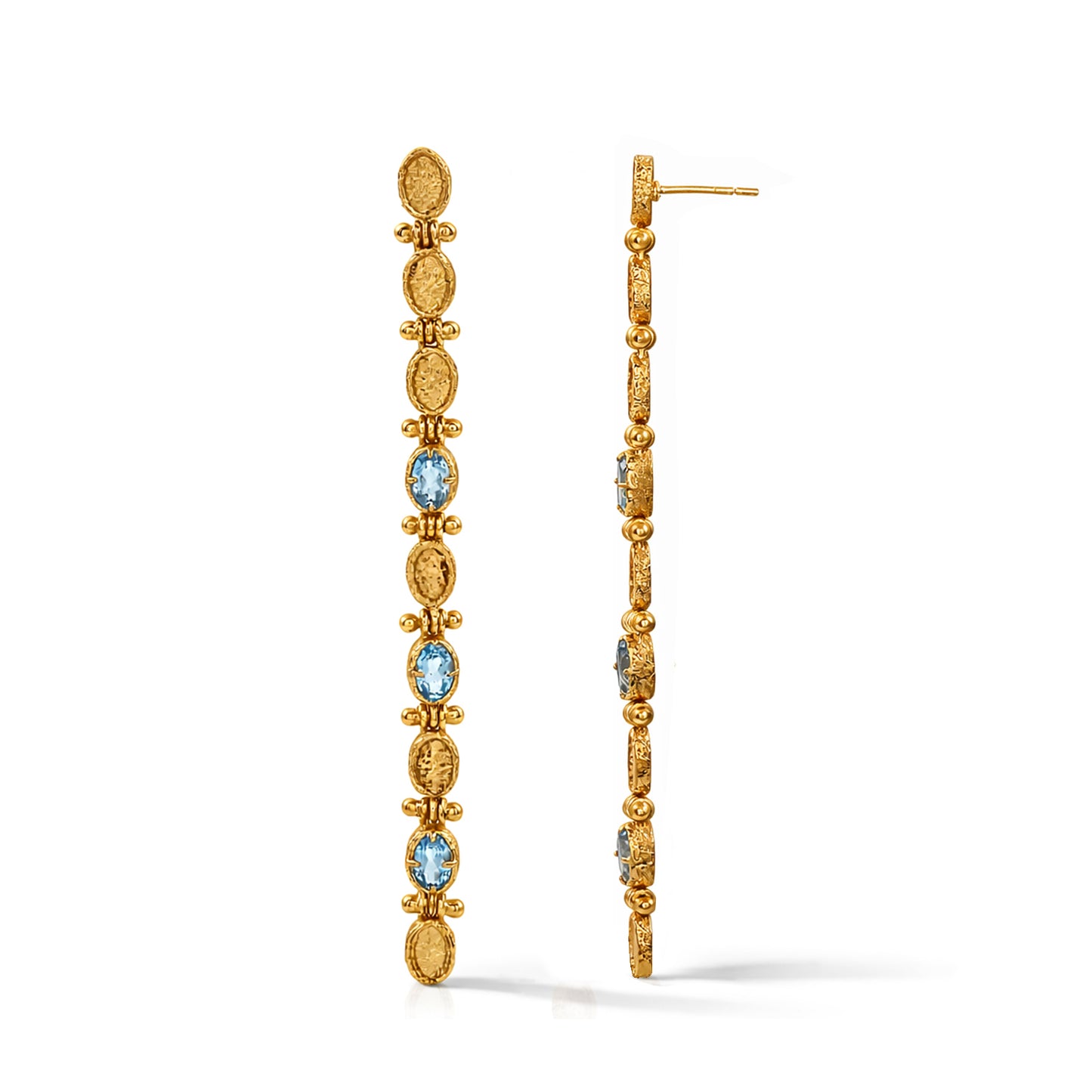 Gold hoop earrings with blue gemstones on a white background