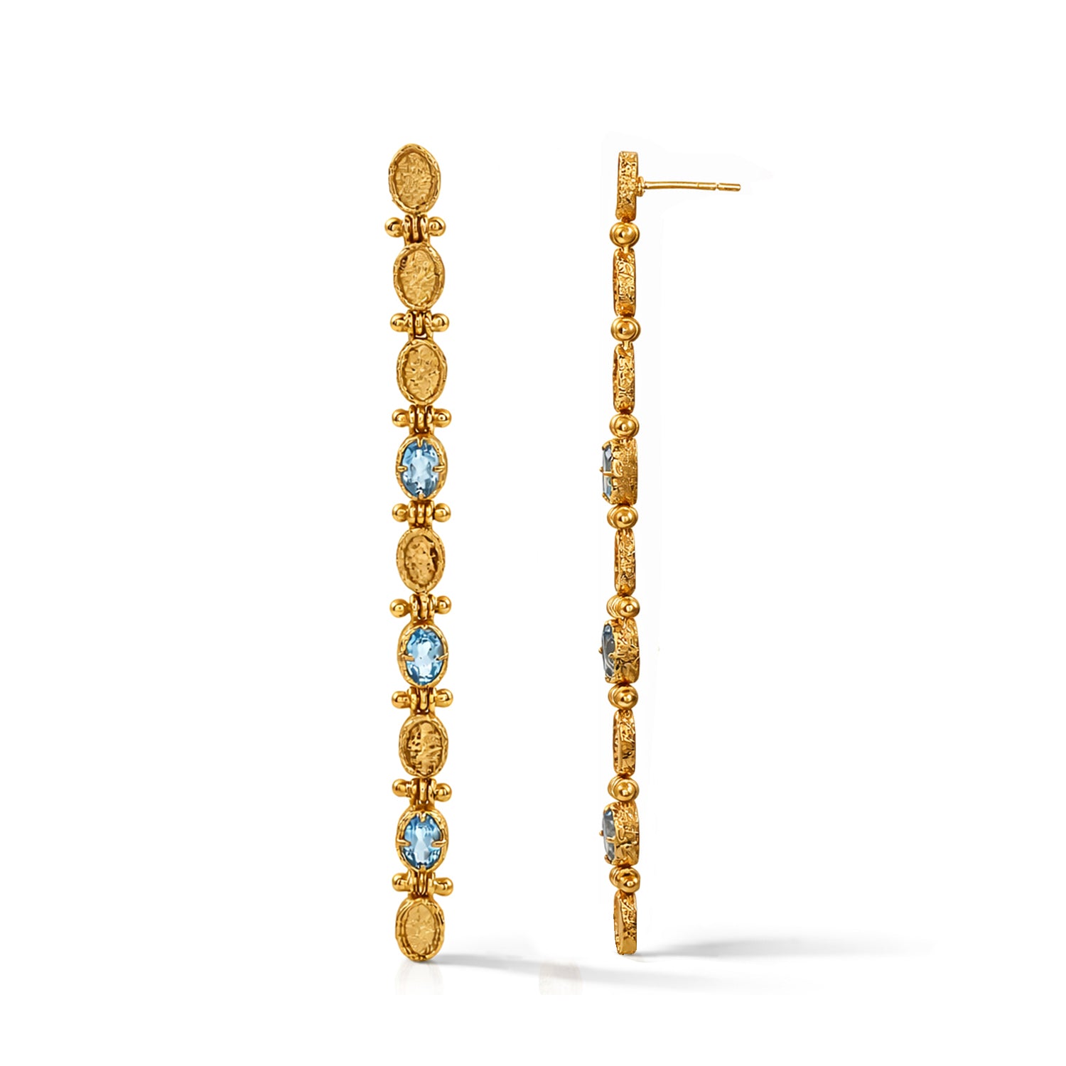 Gold hoop earrings with blue gemstones on a white background