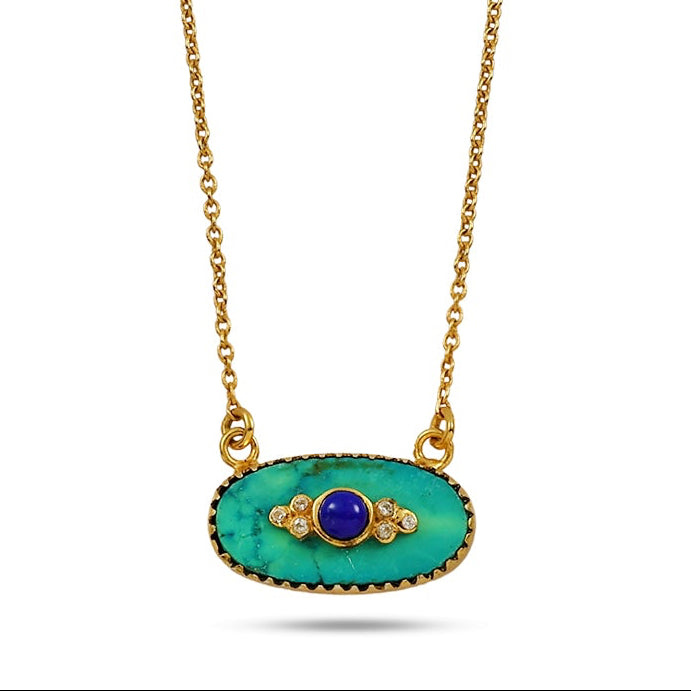 Gold necklace with a green pendant on a white background