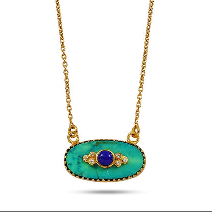 Gold necklace with a green pendant on a white background