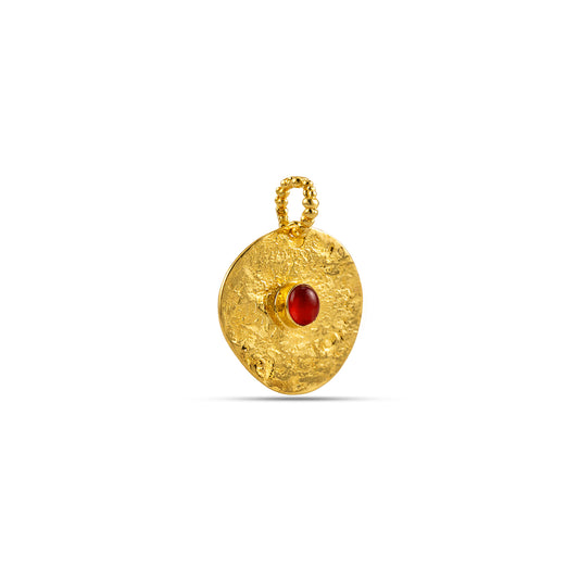 Gold pendant with a red gemstone on a white background