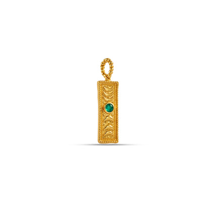 Gold pendant with a green gemstone on a white background