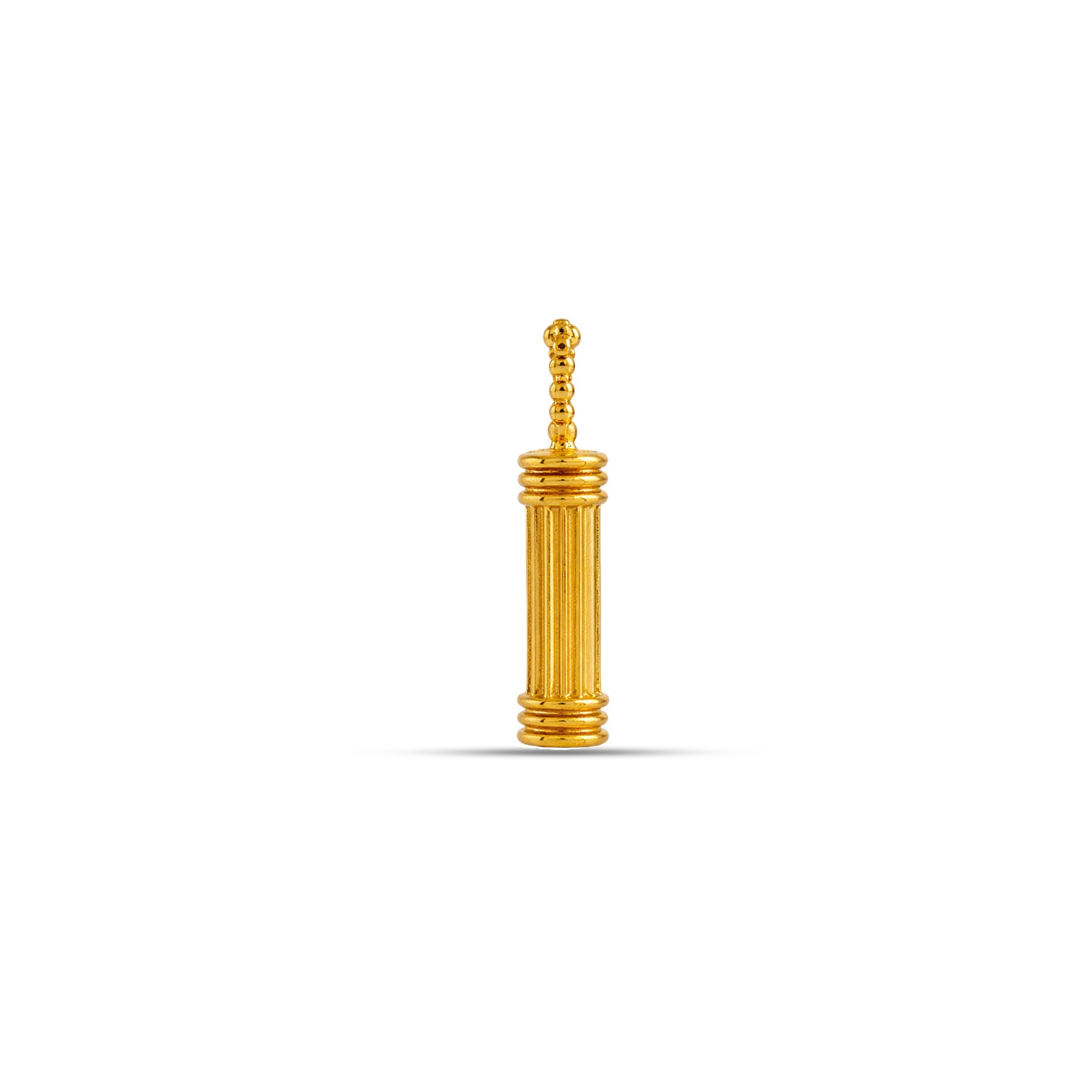 Gold-colored pepper grinder on a white background