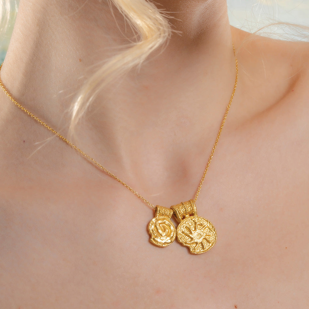 A gold-Plated  necklace with two pendant charms featuring ancient symbols.