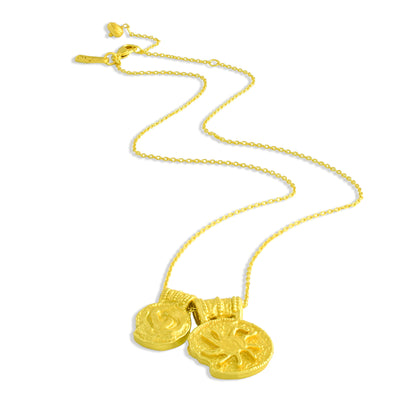 Gold plated necklace with two round ancient charms on a white background