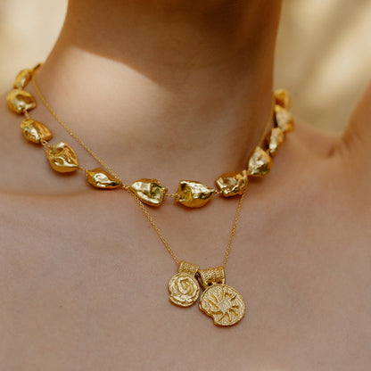 Close up image of person neck wearing Ancient Symbols Charm Necklace by arvino