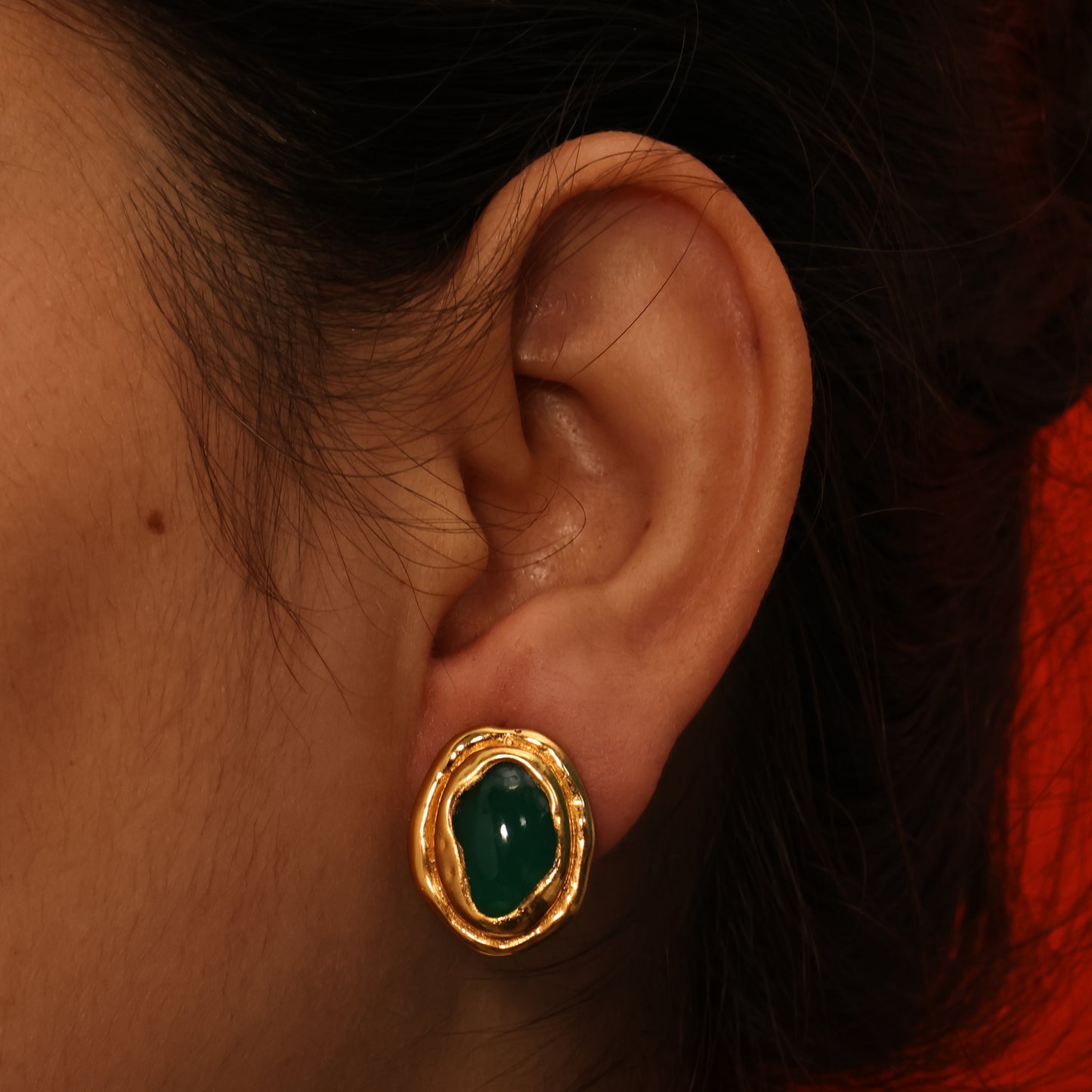 Arvino's Gold plated earring with a green onyx worn by a model. Green Onyx ocean stud from arvino Demi fine jewellery collection