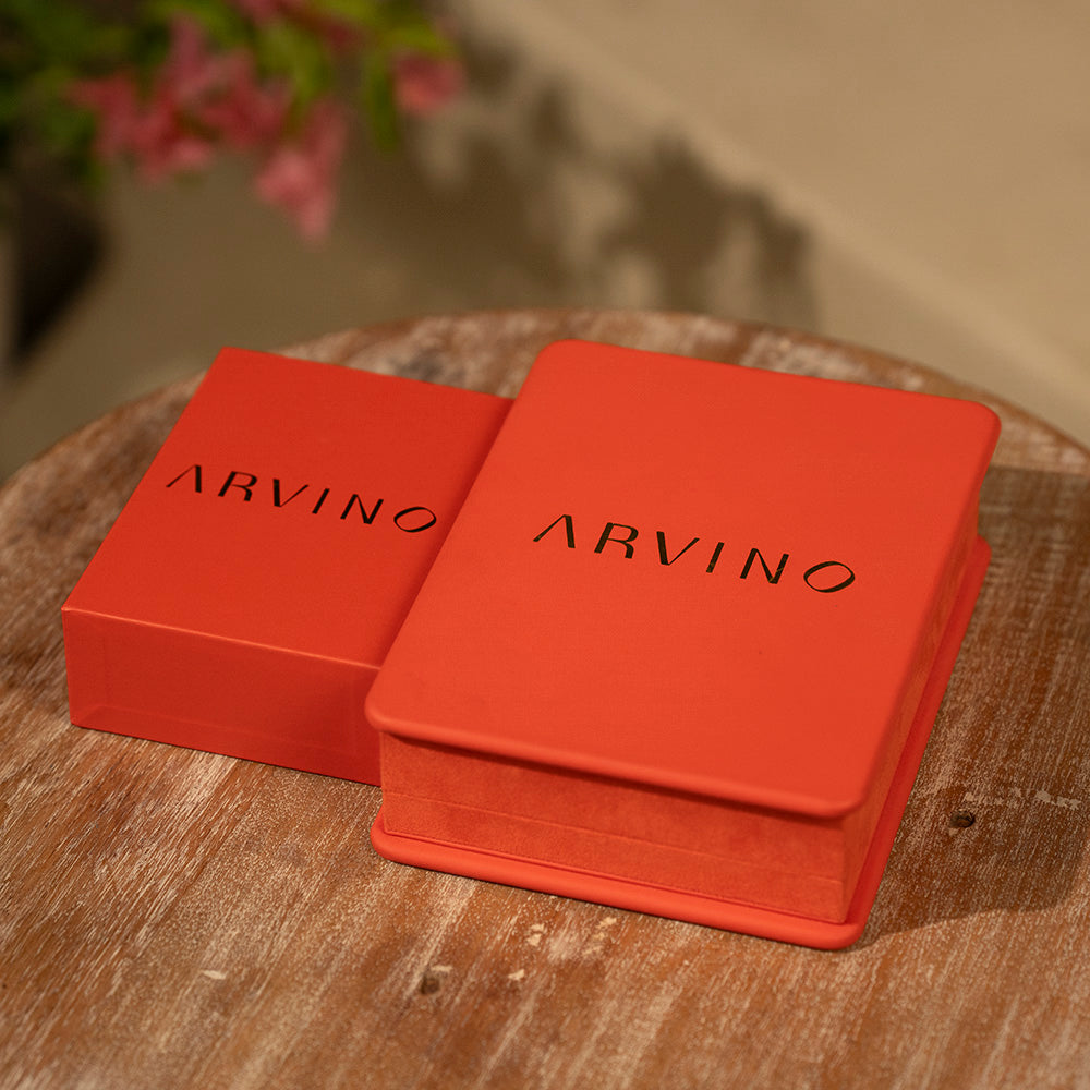 Two red boxes with the brand name 'ARVINO' on them, placed on a wooden surface.