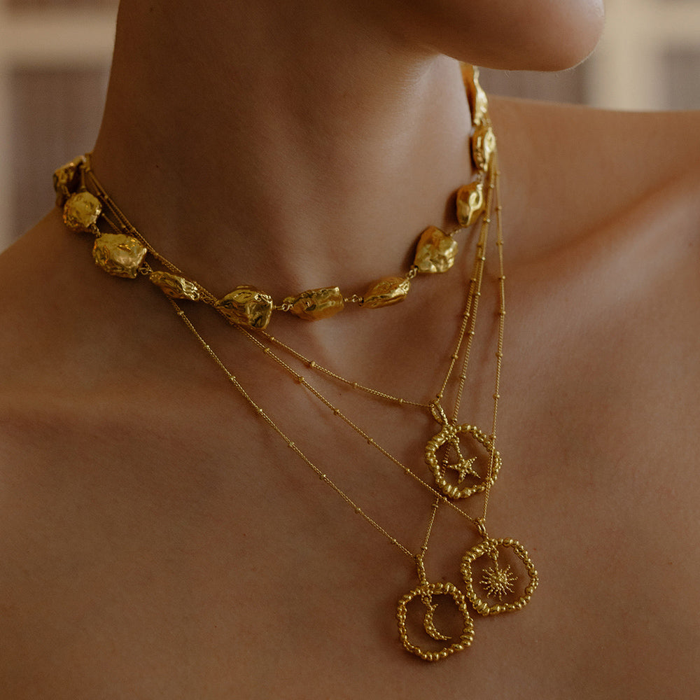 Model Stacking some Gold plated Necklace By arvion From its demi fine jewellery collection
