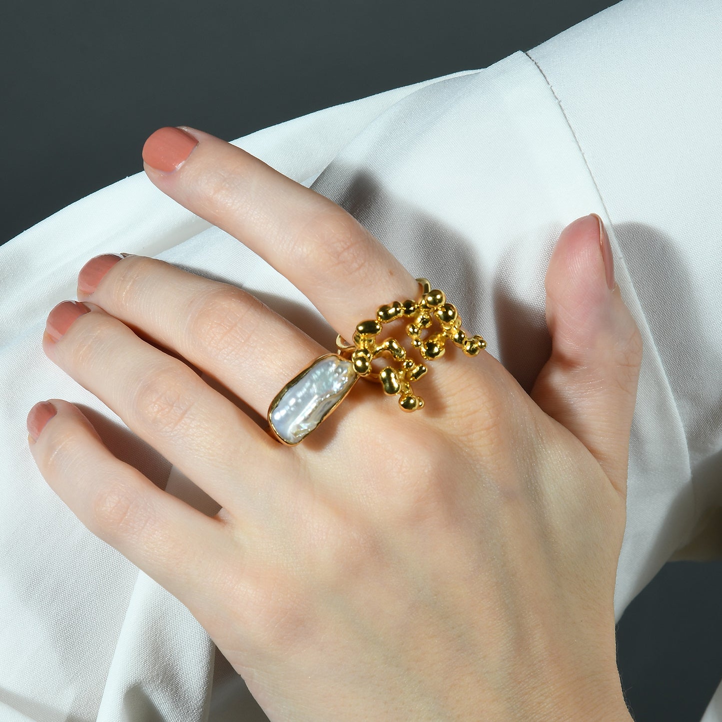 Close Up image of a model stacking Gold plated Ring by arvino
