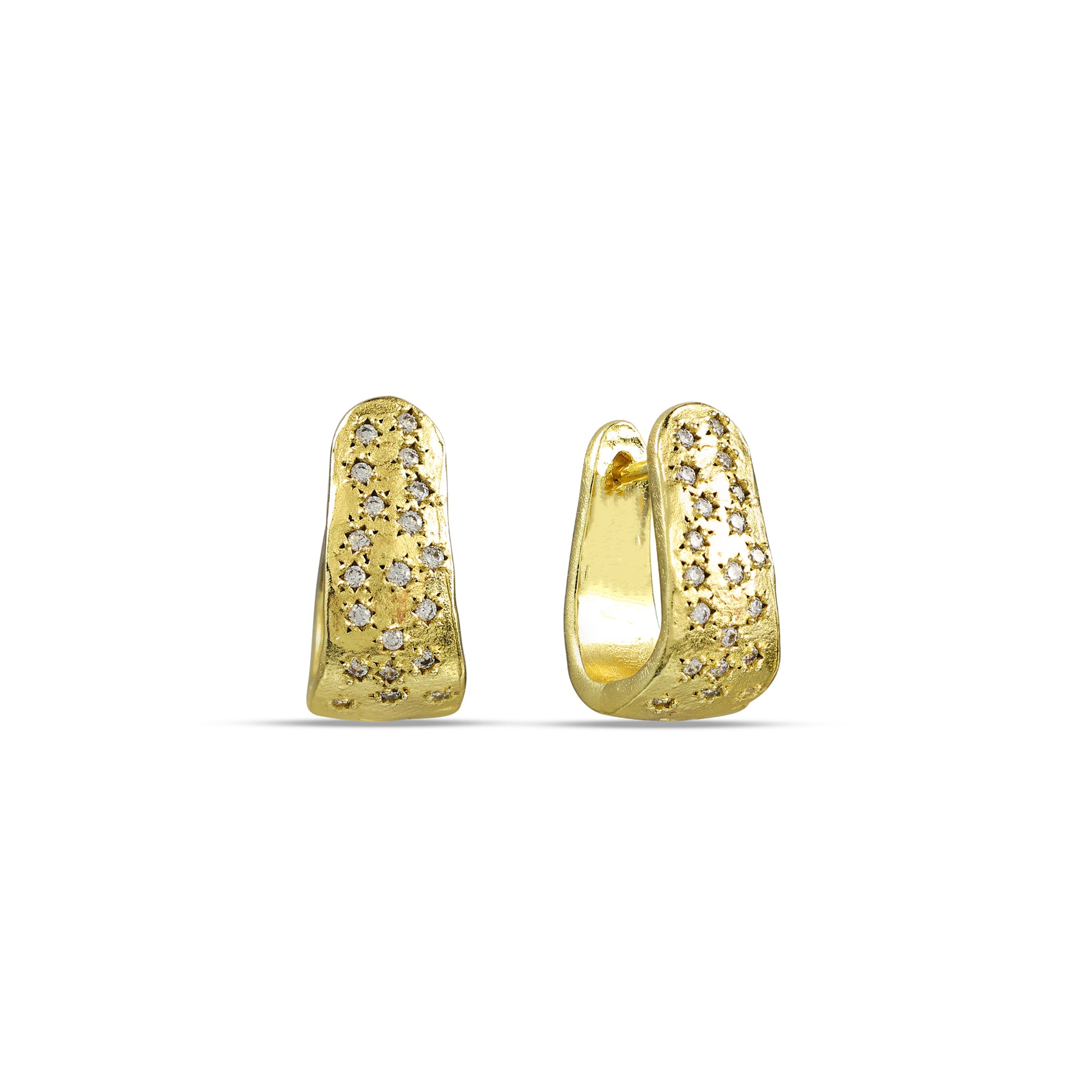 A pair of gold plated huggies earrings studded with shimmering stones.