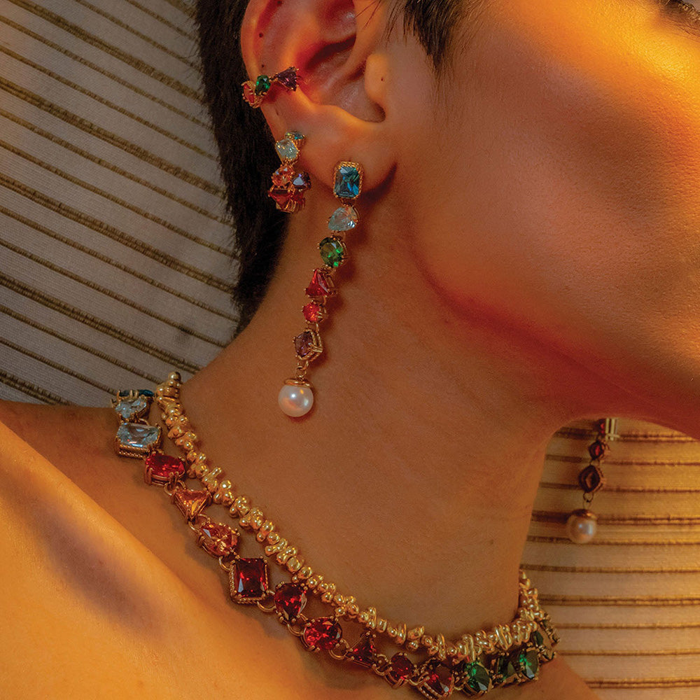 Close shot of model stacking Chromatic Cascade Ear Cuff  with other Ears jewelleries and nacklaces