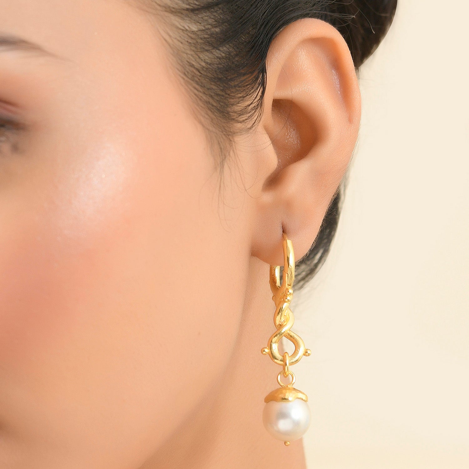 Close up Shot of Model wearing dewy pearl twist drop earrings by Arvino, Earrings made with silver and plated with 22kt real gold