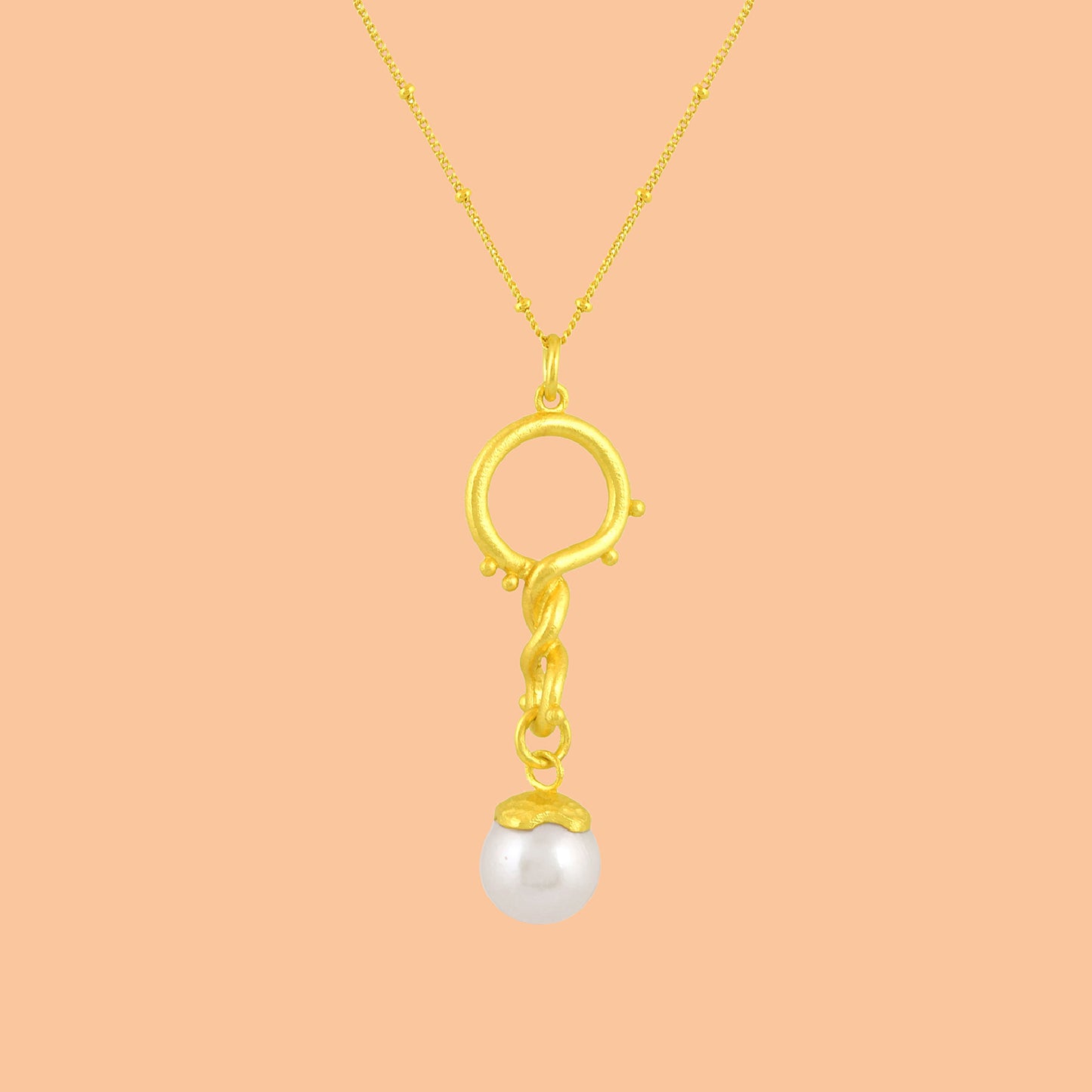 Creative image shot of Dewy Pearl Twist Necklace by arvino on a peach color background