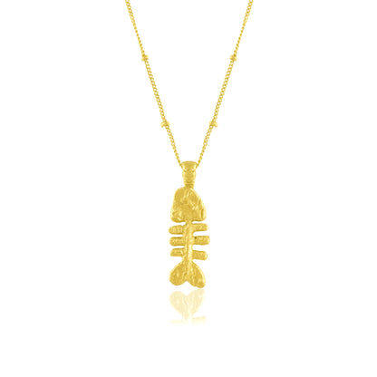  fish bone pendant necklace on a white background. Fish bone pendant  plated in real 22kt gold.