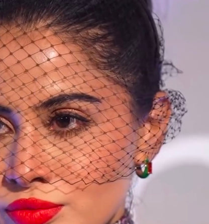 Close up model image of a person wearing Garnet Forest Huggies Earrings by arvino