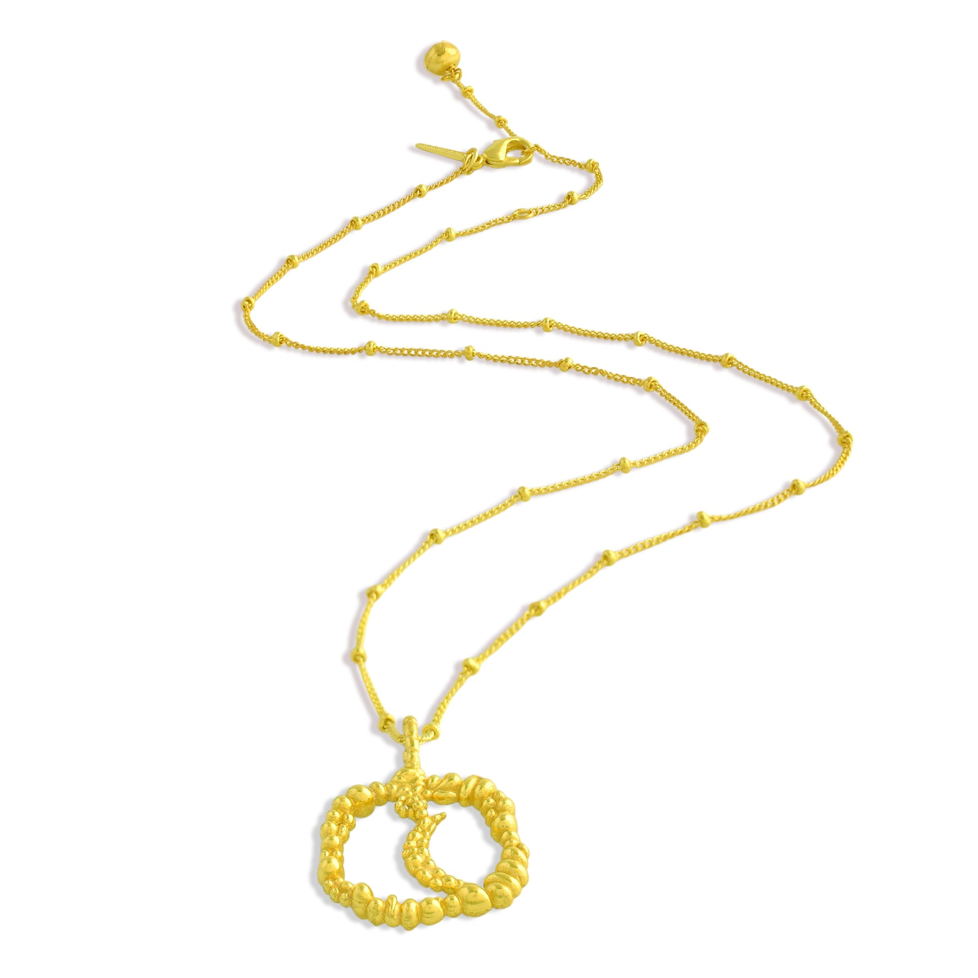 Gold necklace with a moon shaped Granulated pendant on a white background