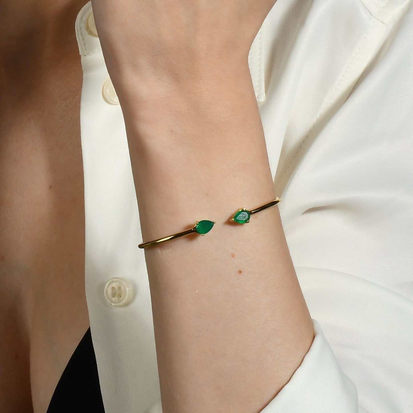Model wearing cuff bracelet on wrist with green onyx.