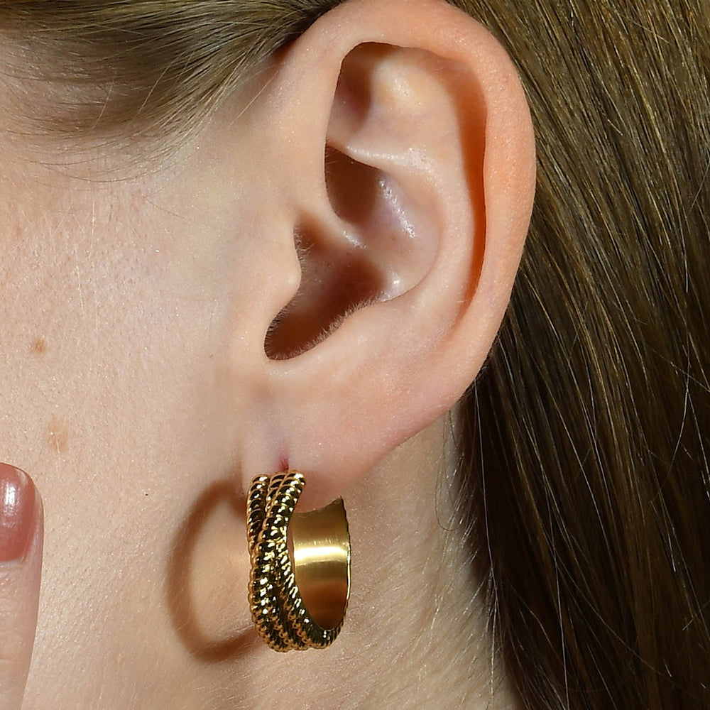 Model image of a person wearing Intertwined Rope Huggies Earrings by arvino.