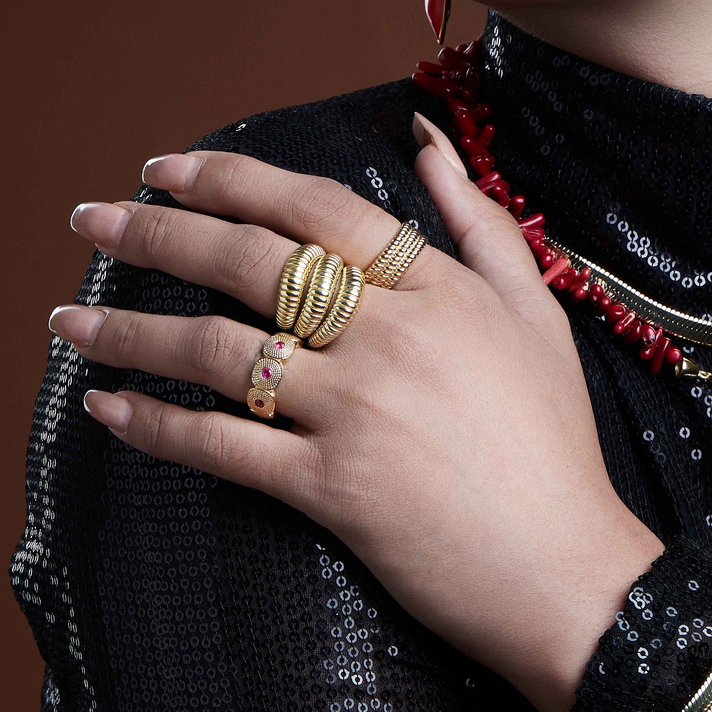 Model Image of a person stacking multiple gold plated rings by arvino
