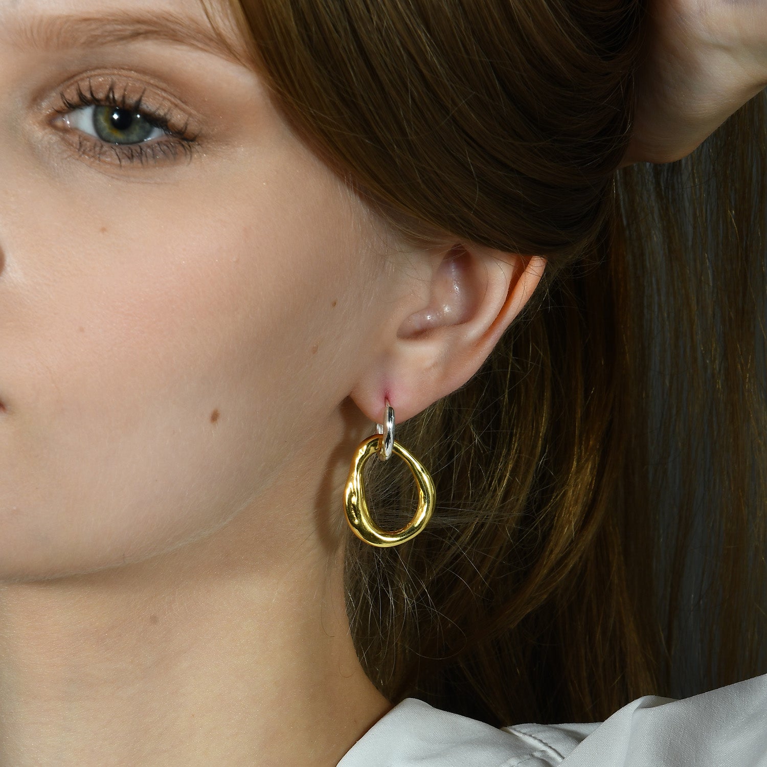 Model Wearing Modern Dual Tone Hoop Earrings by Arvino. Best Gold Plated Earrings