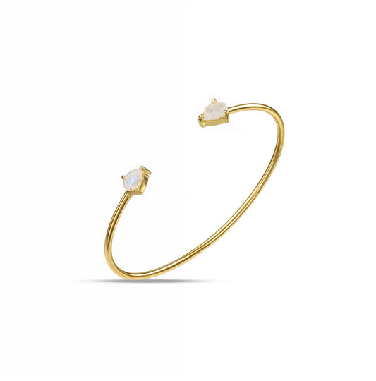 A gold cuff bracelet featuring two rainbow moonstones set at each end.