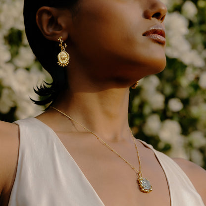 Model wearing Morsel Shell Earrings By arvino with a gold plated Pendant.
Premium Gold Plated Earrings By Arvino.