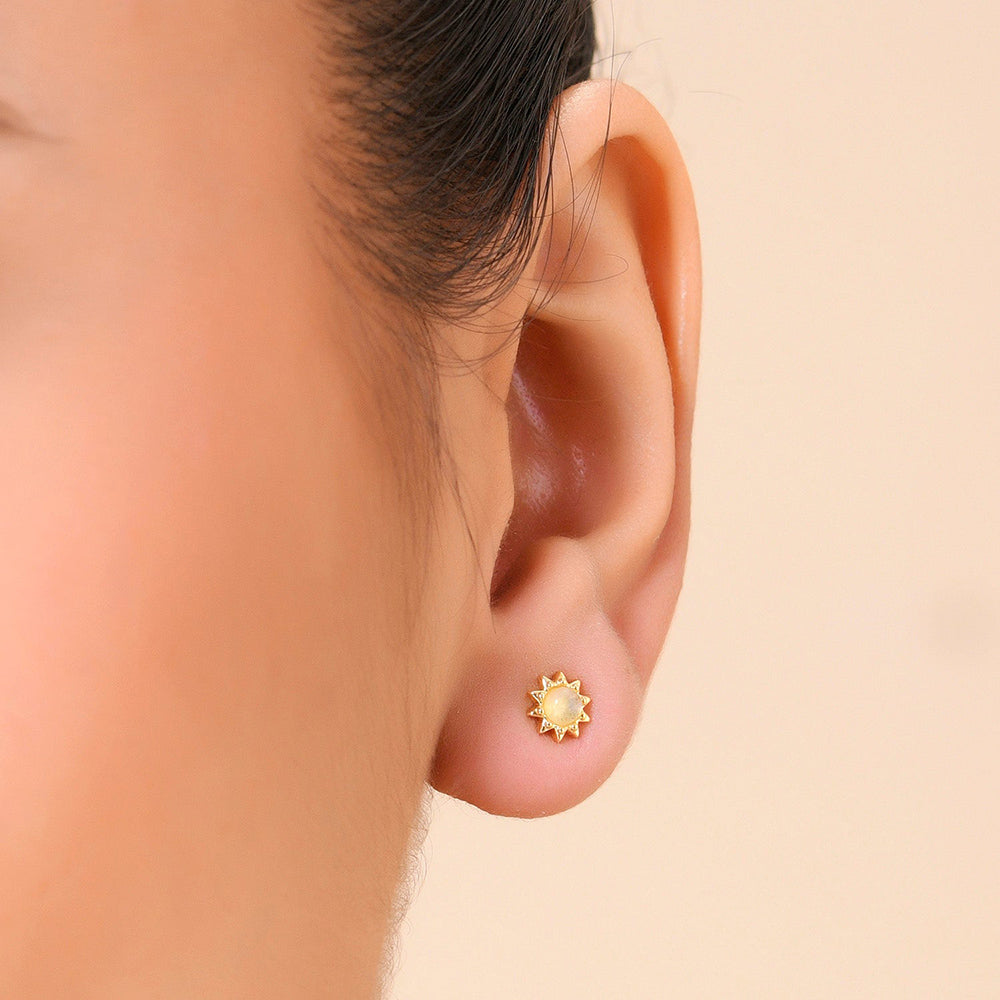 A person wearing a Gold plated stud earring with a Little Labradorite Stone