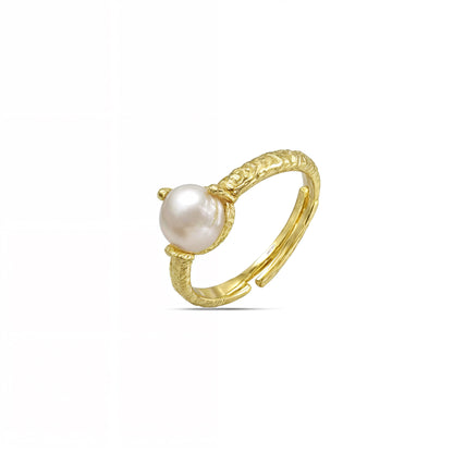 A Gold Plated Ring with a lustrous pearl centerpiece, featuring organic-shaped sides.