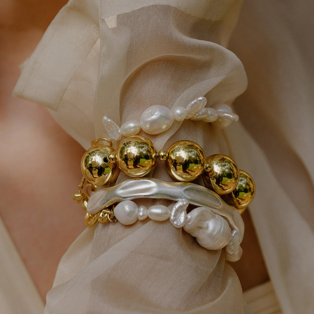 Model stacking Pearl bracelet in wrist by arvino