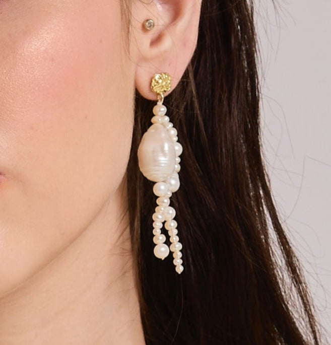Arvino's Pearl Weave earrings worn by a model with a neutral background.