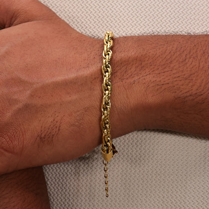 Gold plated chain bracelet on a wrist with a neutral white background. Rugged flow men's bracelet by arvino's demi fine jewellery collection