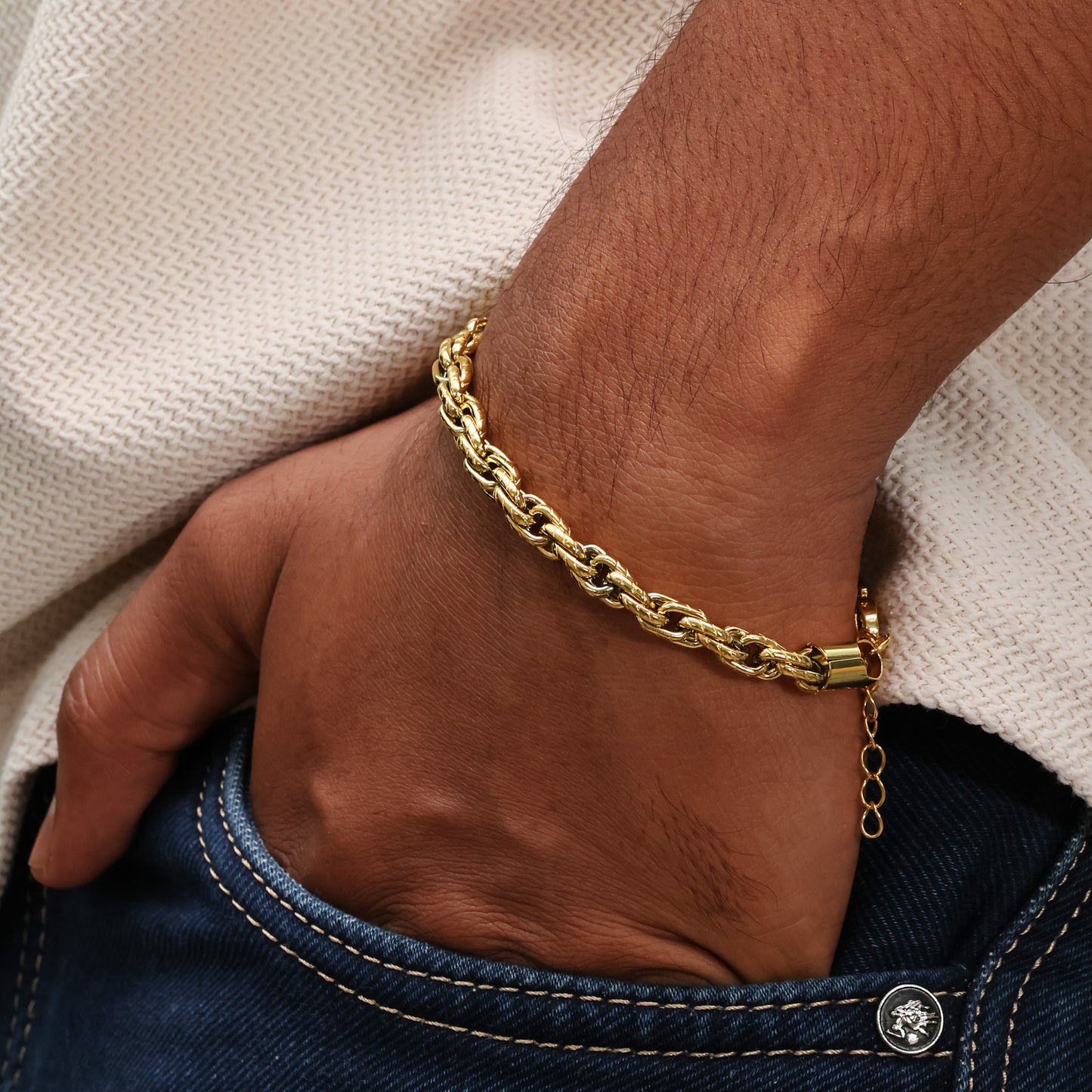 Arvino's Rugged Flow mens bracelet Gold plated on model hand in pocket.
