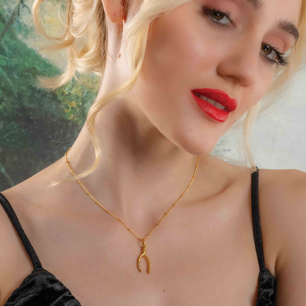 Model Wearing Scraggy Wishbone Luck Necklace By Arvino. Gold Plated SIlver Necklace By Arvino.