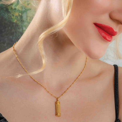 Model Shot Wearing Sculpted Pillar Necklace. Gold Plated Necklace By Arvino.