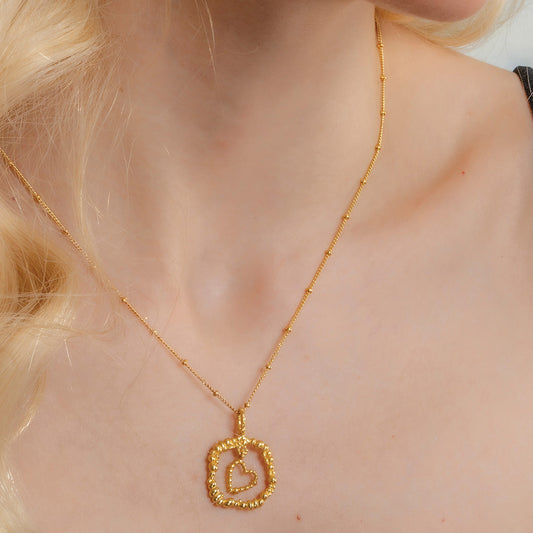 Model Wearing Gold plated Granulated Heart Necklace In 925 Sterling Silver By Arvino