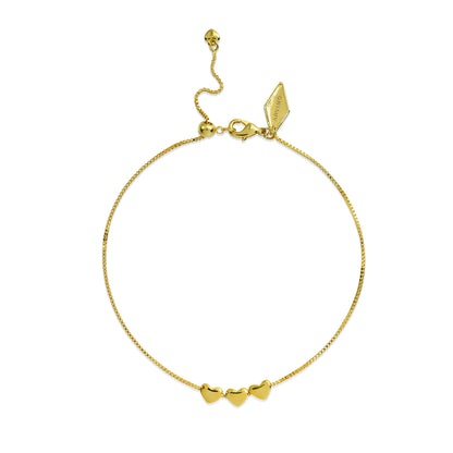 Gold bracelet with heart-shaped charms on a white background