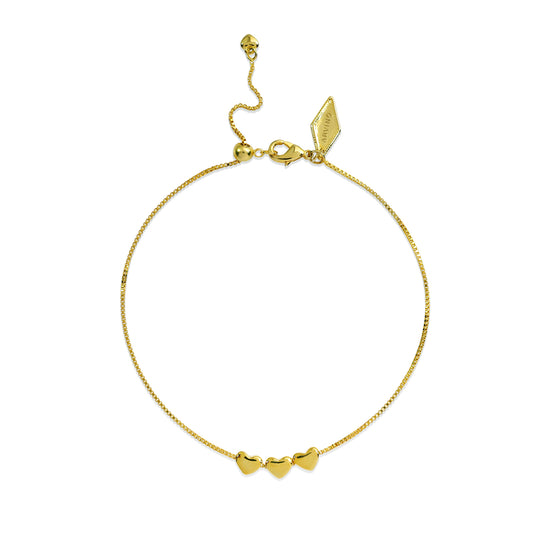 Gold bracelet with heart-shaped charms on a white background
